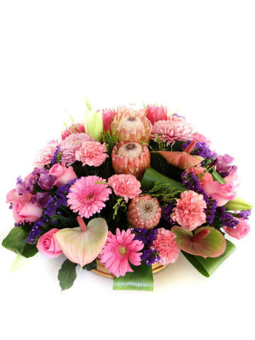 Roses, carnations, proteas and other flowers styled in basket
