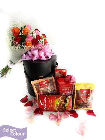 An arrangement of roses in netting with a variety of chocolates
