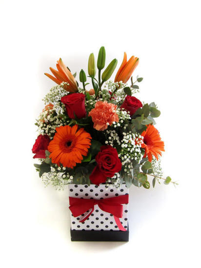 Box filled with roses, carnations, gerberas and lilies