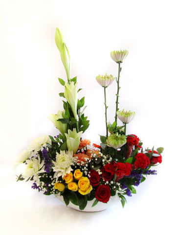 Mixed flowers arranged in ceramic pot