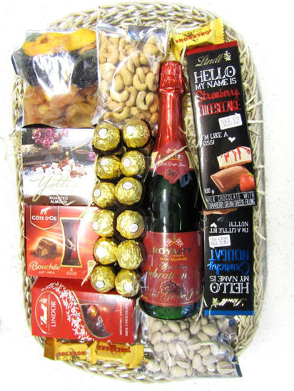 Sparkling juice, chocolates, dried fruit and nuts packed in flat tray