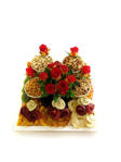 Dried fruit and nuts with roses on wooden tray