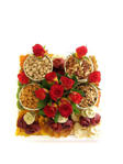 Dried fruit and nuts with roses on wooden tray
