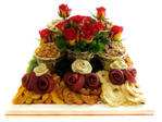 Dried fruit and nuts with roses on wooden tray