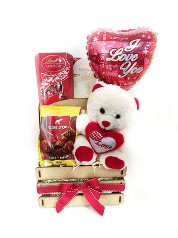 Roses, chocolates and teddy in wooden crate
