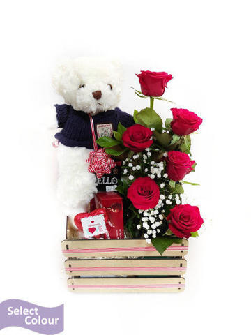 Roses, chocolates and teddy in wooden crate